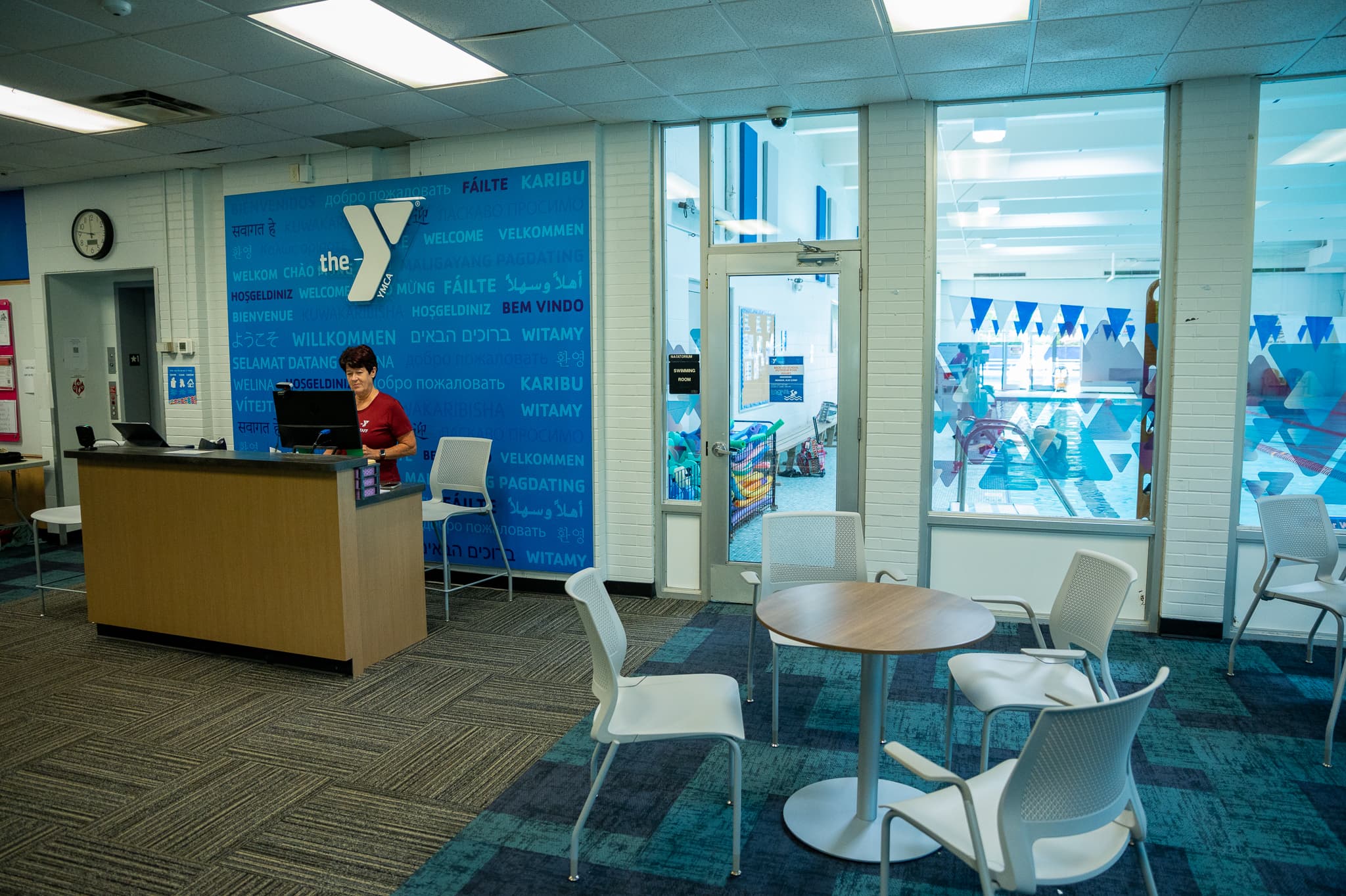Welcome desk and multilingual welcome wall at the Blue Ash YMCA