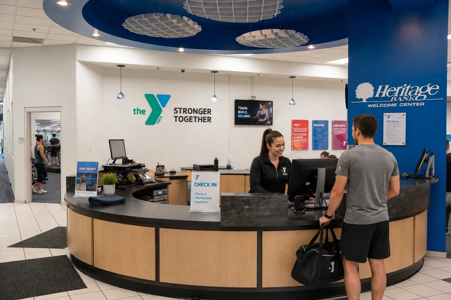 Staff helping a member check in at the R.C. Durr YMCA welcome center